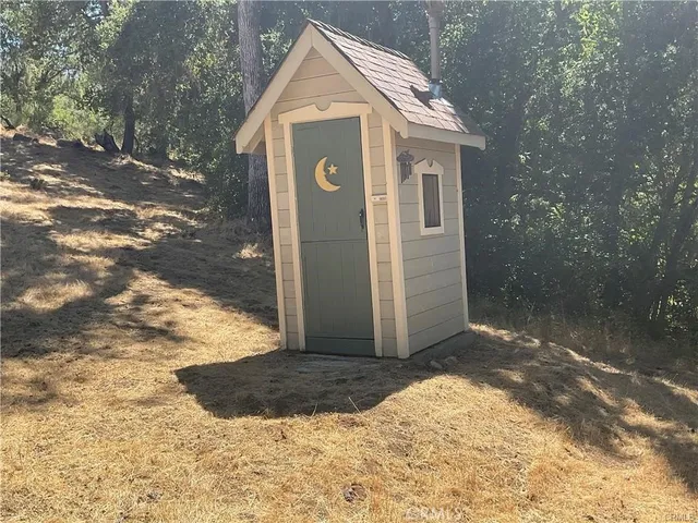 a view of a wooden house with a yard