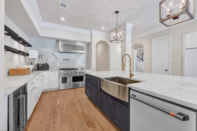 a kitchen with stainless steel appliances granite countertop a sink stove and refrigerator