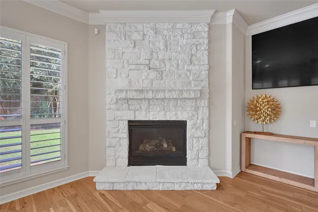 a living room with a fireplace and a flat screen tv