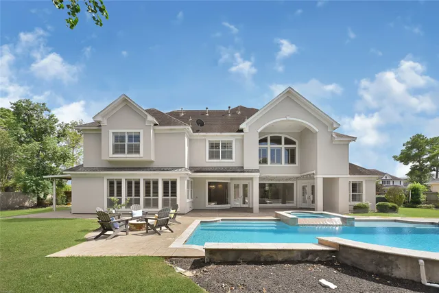 a front view of a house with swimming pool having outdoor seating