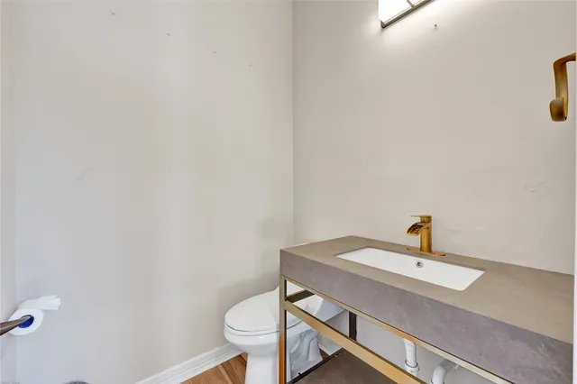 a bathroom with a sink a toilet and mirror