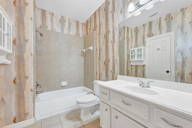 a bathroom with a sink a toilet a mirror and a shower