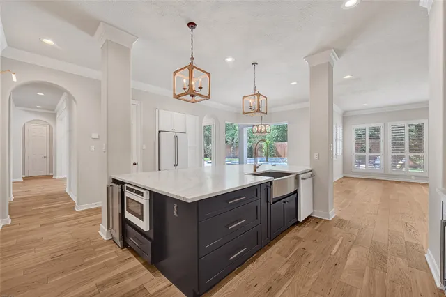 a kitchen with stainless steel appliances granite countertop a lot of counter space and wooden floors