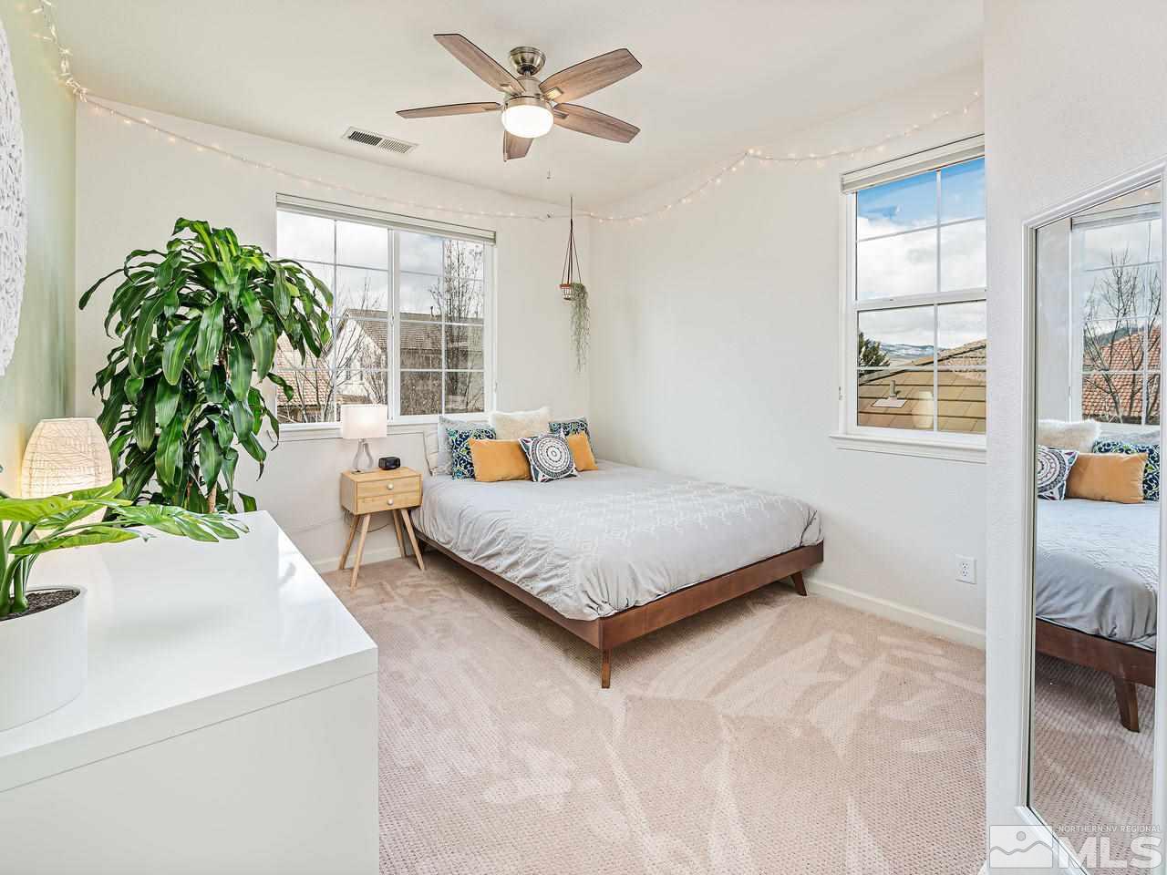 570 Little Sorrel Court Reno, NV 89521 - Photo 13 of 16 a bedroom with a bed and a potted plant