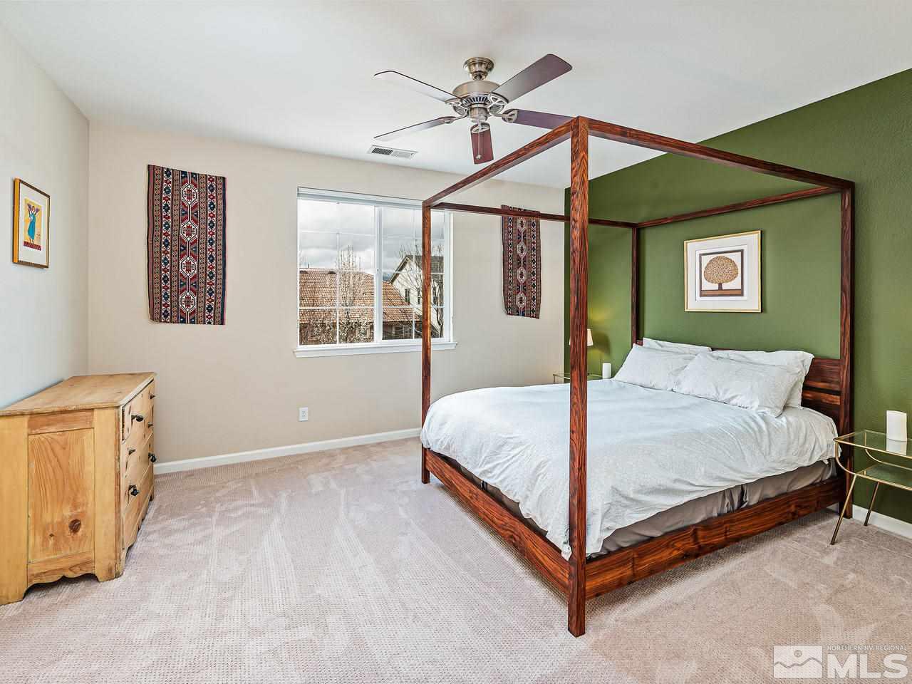 570 Little Sorrel Court Reno, NV 89521 - Photo 9 of 16 a bedroom with a bed mirror and a window