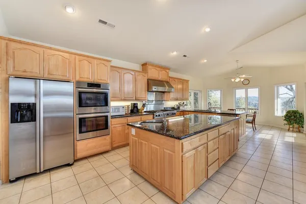 a kitchen with granite countertop a sink and cabinets