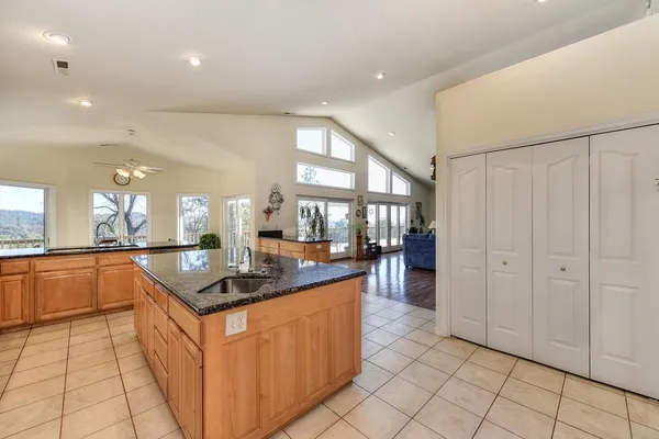 a kitchen with granite countertop a sink and cabinets