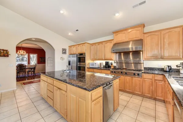 a kitchen with granite countertop a sink and cabinets