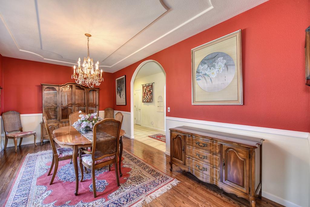 24200 Golden Ridge Drive Volcano, CA 95689 - Photo 19 of 58 a dining room with furniture a chandelier and wooden floor