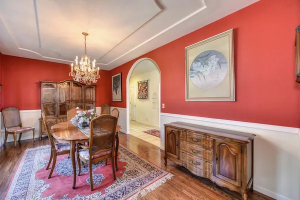 a dining room with furniture a chandelier and window