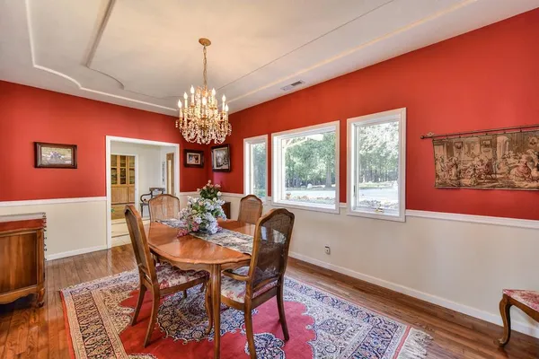 a view of a dining room with furniture and chandelier