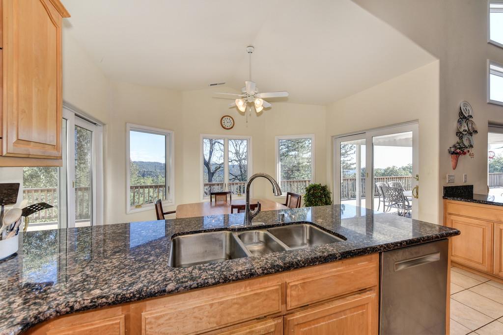 24200 Golden Ridge Drive Volcano, CA 95689 - Photo 24 of 58 a kitchen with granite countertop a sink and a large window