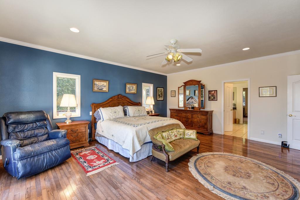 24200 Golden Ridge Drive Volcano, CA 95689 - Photo 27 of 58 a spacious bedroom with a bed a couch and dresser