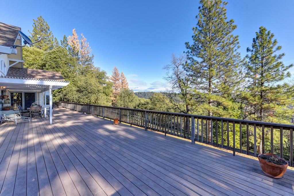 24200 Golden Ridge Drive Volcano, CA 95689 - Photo 33 of 59 a view of a balcony with wooden floor and outdoor seating