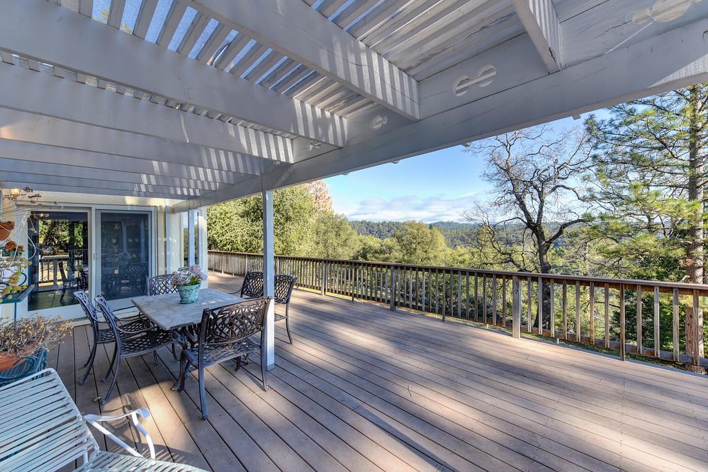 24200 Golden Ridge Drive Volcano, CA 95689 - Photo 35 of 58 a view of a patio with wooden floor table and chairs