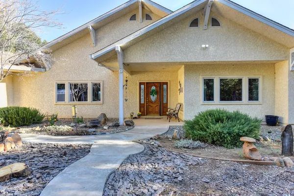 an aerial view of a house with a yard and balcony