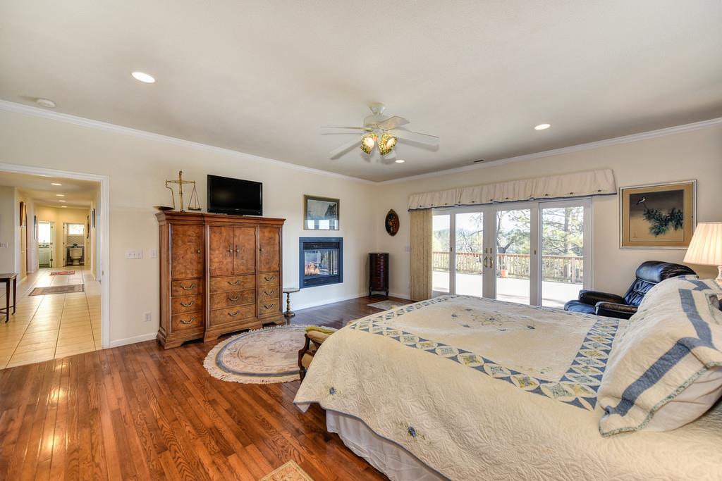 24200 Golden Ridge Drive Volcano, CA 95689 - Photo 41 of 59 a spacious bedroom with a bed and a flat screen tv