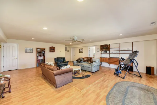 a living room with furniture and a floor to ceiling window