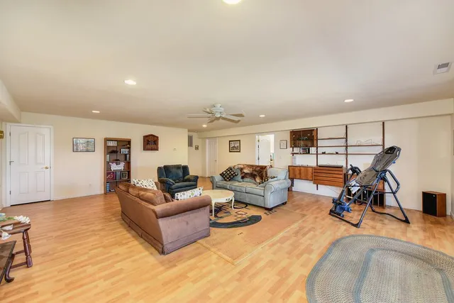 a living room with furniture and a floor to ceiling window
