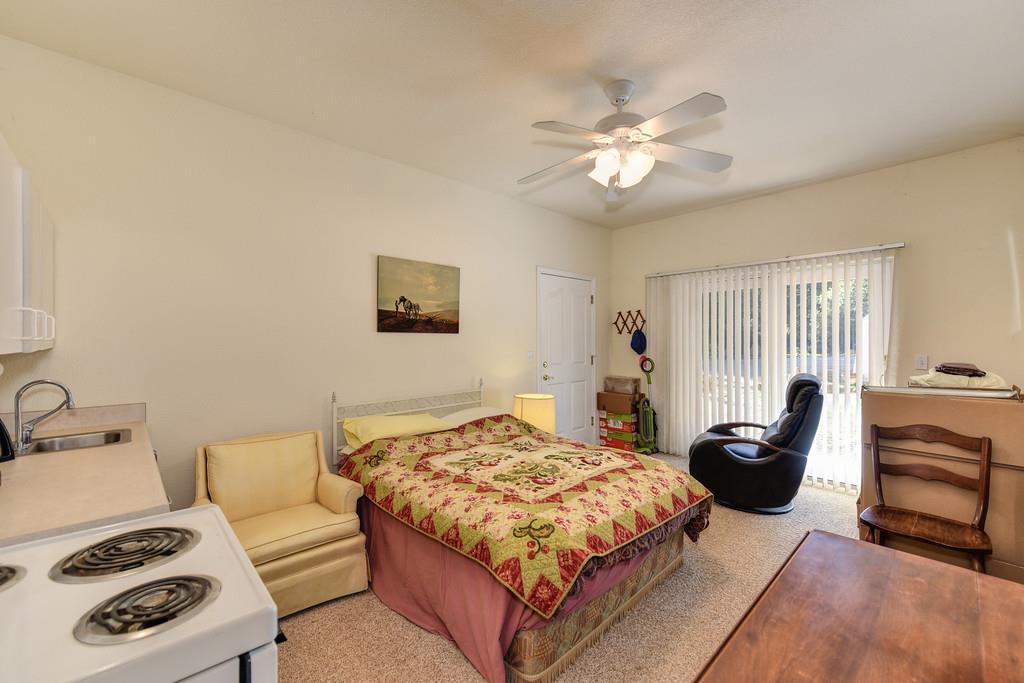 24200 Golden Ridge Drive Volcano, CA 95689 - Photo 56 of 58 a bedroom with a bed and dresser with the outer view