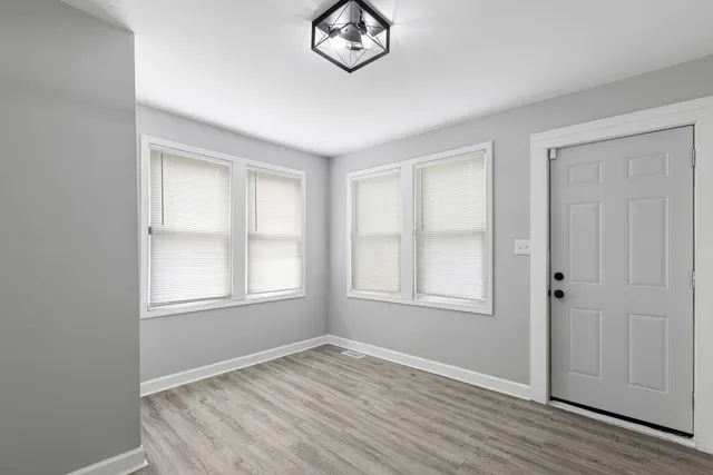 an empty room with windows and closet