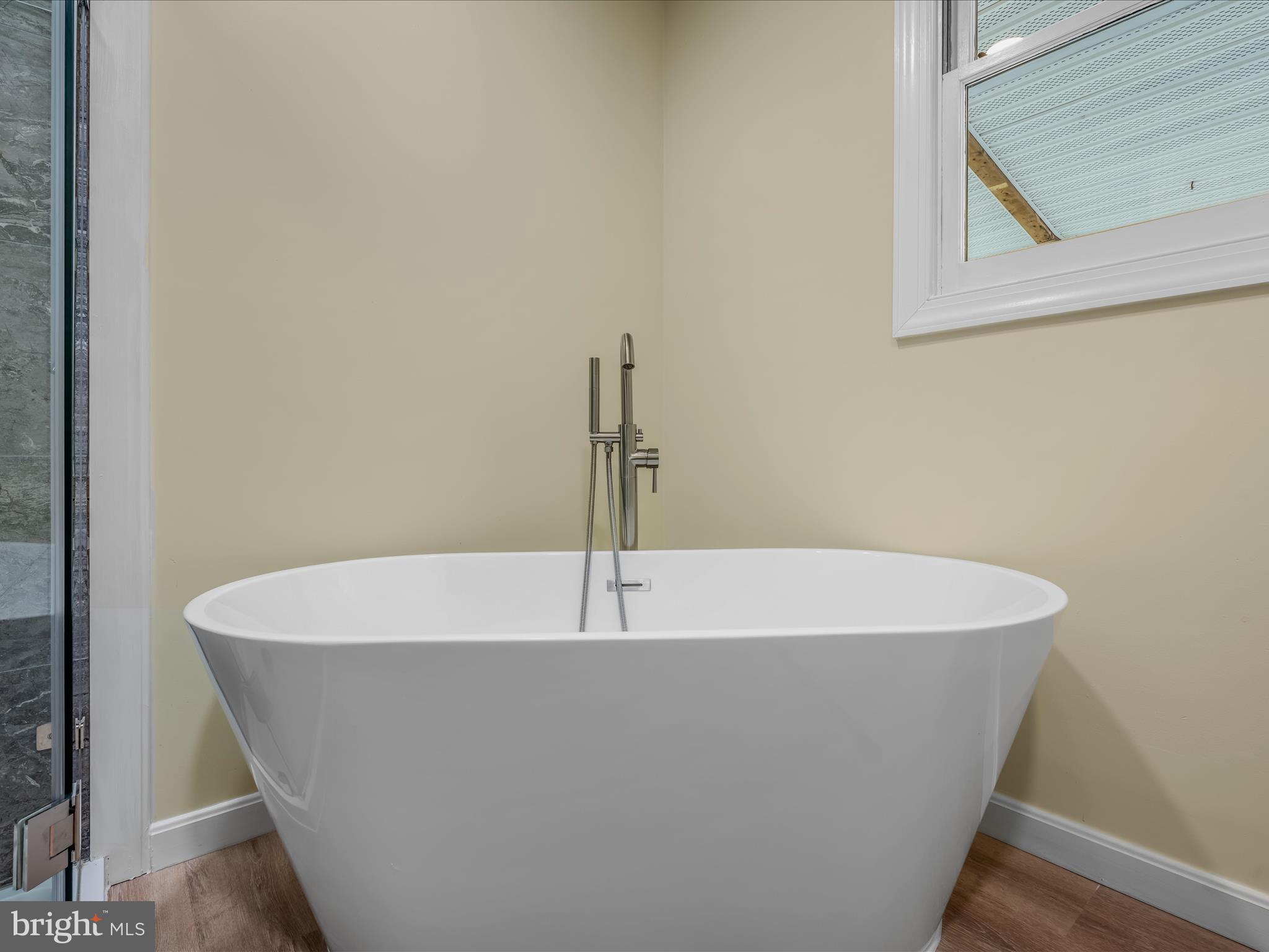 3939 Virginia Line Road Berkeley Springs, WV 25411 - Photo 19 of 51 a white tub sitting in a bathroom