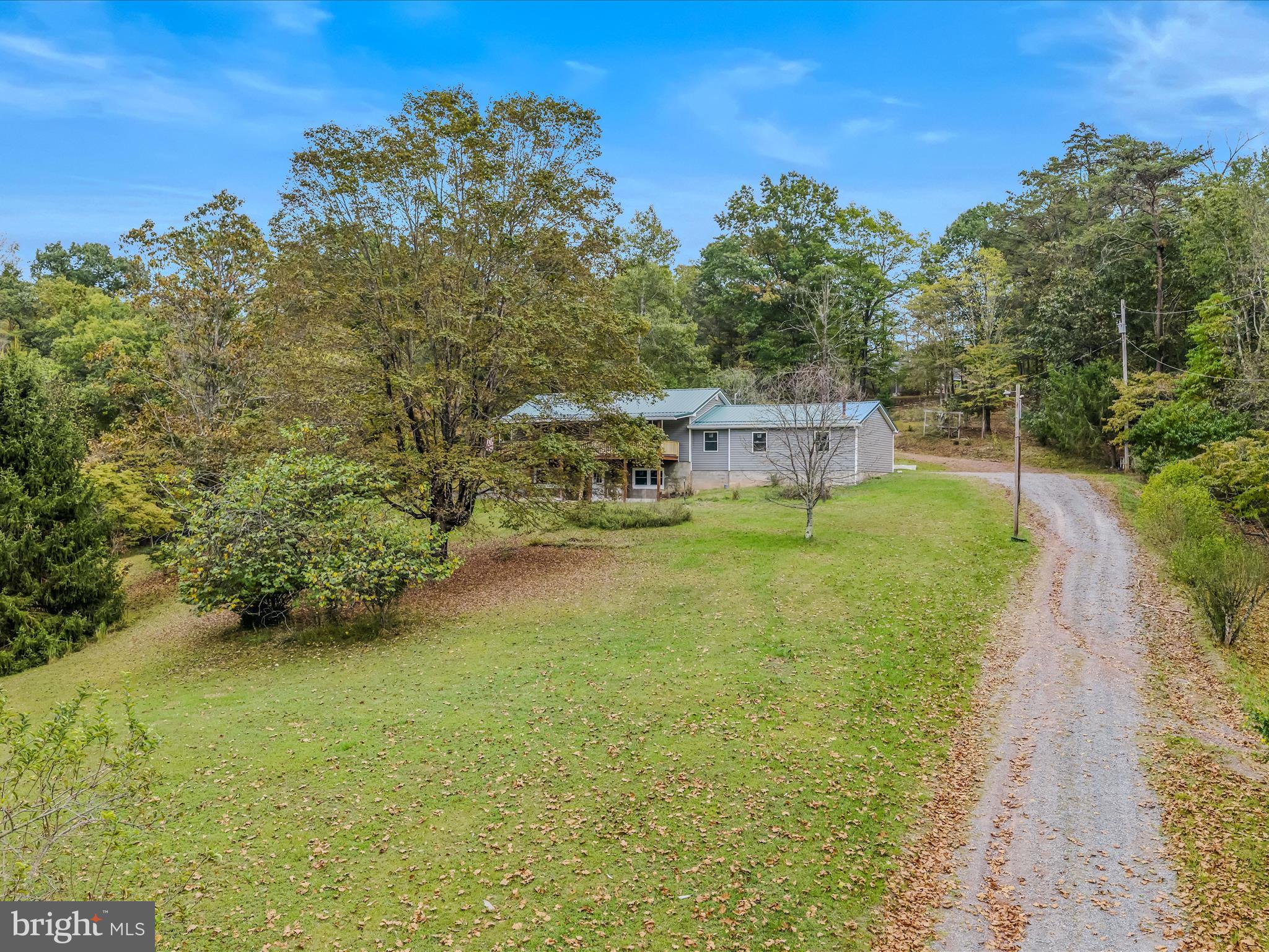3939 Virginia Line Road Berkeley Springs, WV 25411 - Photo 34 of 51 a view of a house with a yard