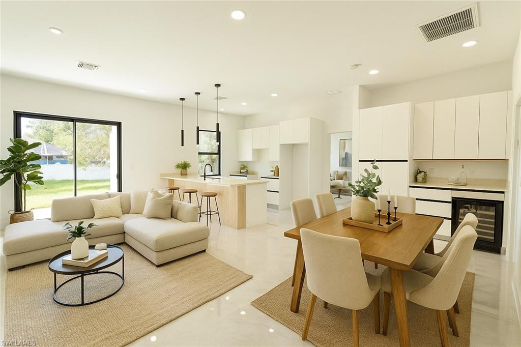 2522 Alice Place Lehigh Acres, FL 33971 - Photo 11 of 34 a living room with furniture kitchen and a large window