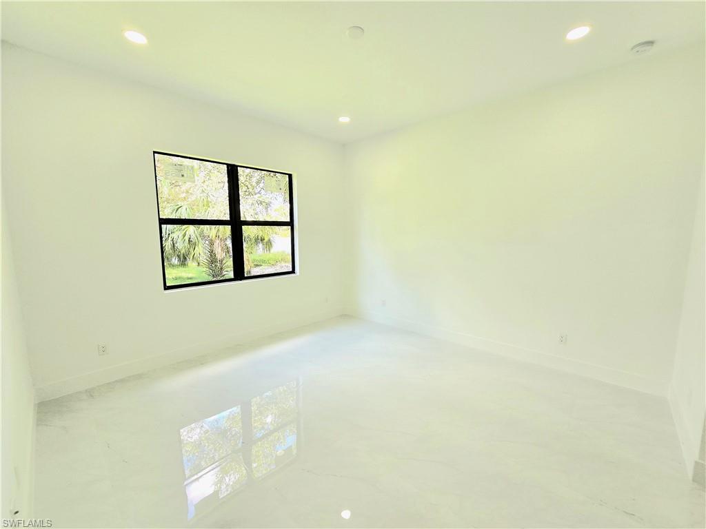 2522 Alice Place Lehigh Acres, FL 33971 - Photo 16 of 34 a view of an empty room with windows