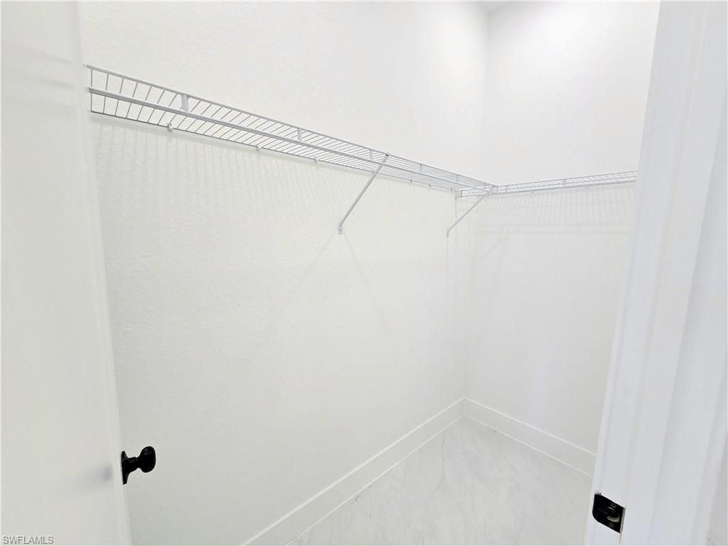 2522 Alice Place Lehigh Acres, FL 33971 - Photo 20 of 34 a view of a room with racks on the wall