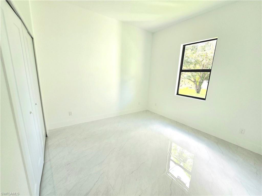 2522 Alice Place Lehigh Acres, FL 33971 - Photo 25 of 34 a view of empty room with windows
