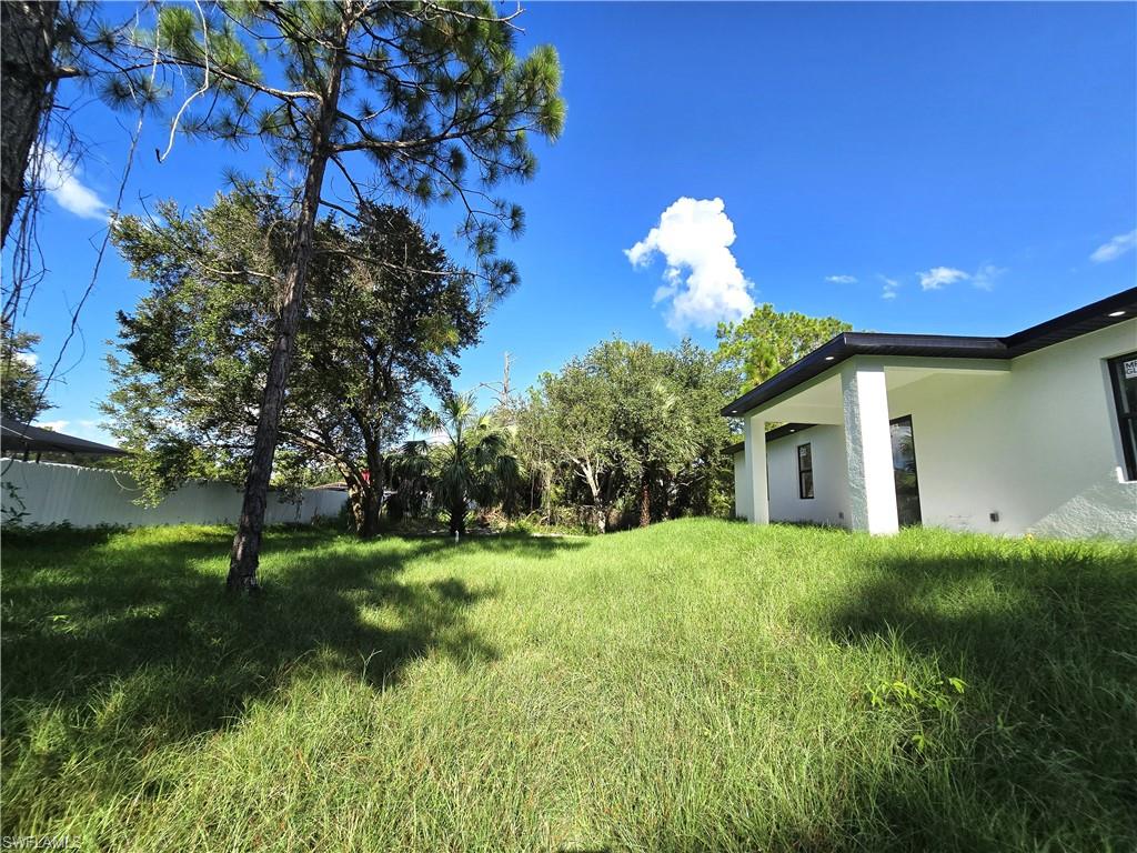 2522 Alice Place Lehigh Acres, FL 33971 - Photo 32 of 34 a house view with a garden space