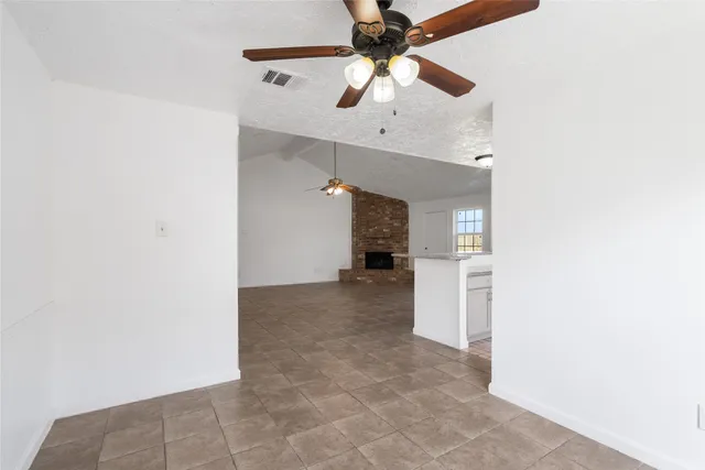 an empty room with a ceiling fan and a ceiling fan