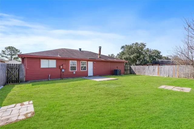 a view of an house with backyard space and garden