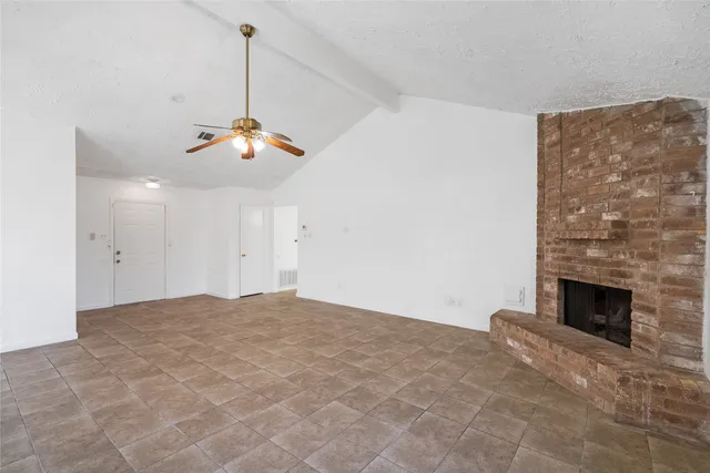 a view of an empty room with a fireplace