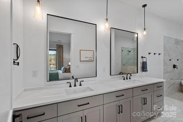 a bathroom with double vanity sinks and a mirror