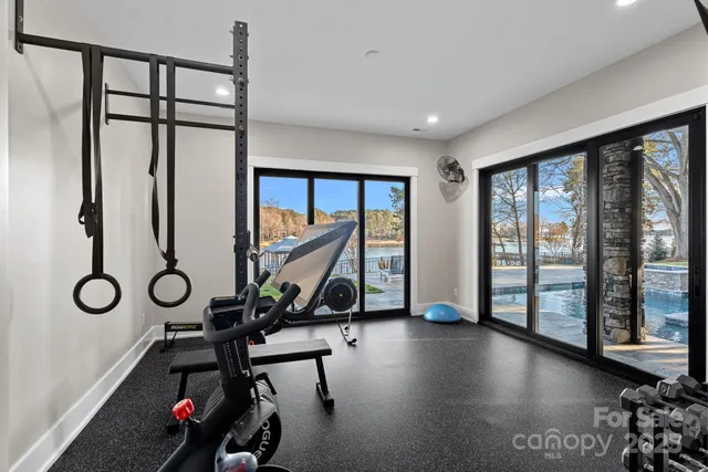 a spacious bedroom with a bed and glass door