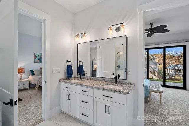 a bedroom with a bed and a large window