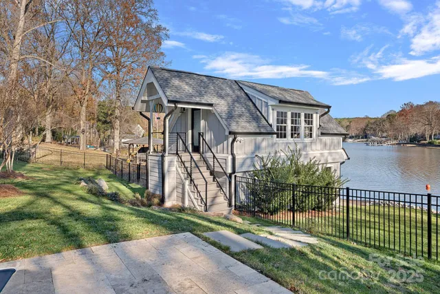 a living room with furniture a wooden floor and a chandelier