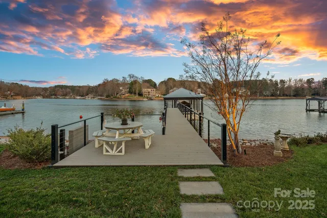 a view of a chairs and table on the roof deck