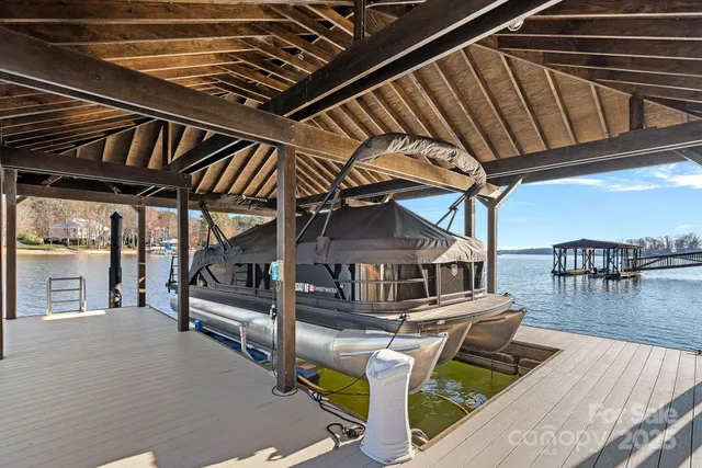 a view of a lake with couches chairs and a table