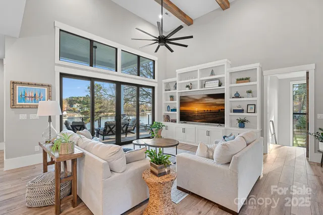 a living room with furniture tv and a flat screen tv