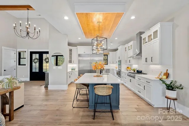 a large kitchen with a table and chairs