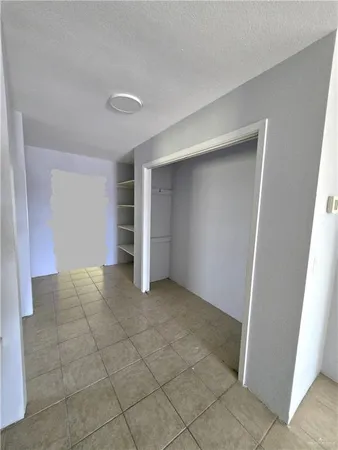 a view of an empty room with a fireplace
