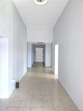 a view of a room with an empty space and a window