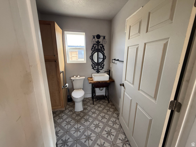 14183 High Mesa Loop Duchesne, UT 84021 - Photo 40 of 56 Half bathroom with light flooring and a textured ceiling