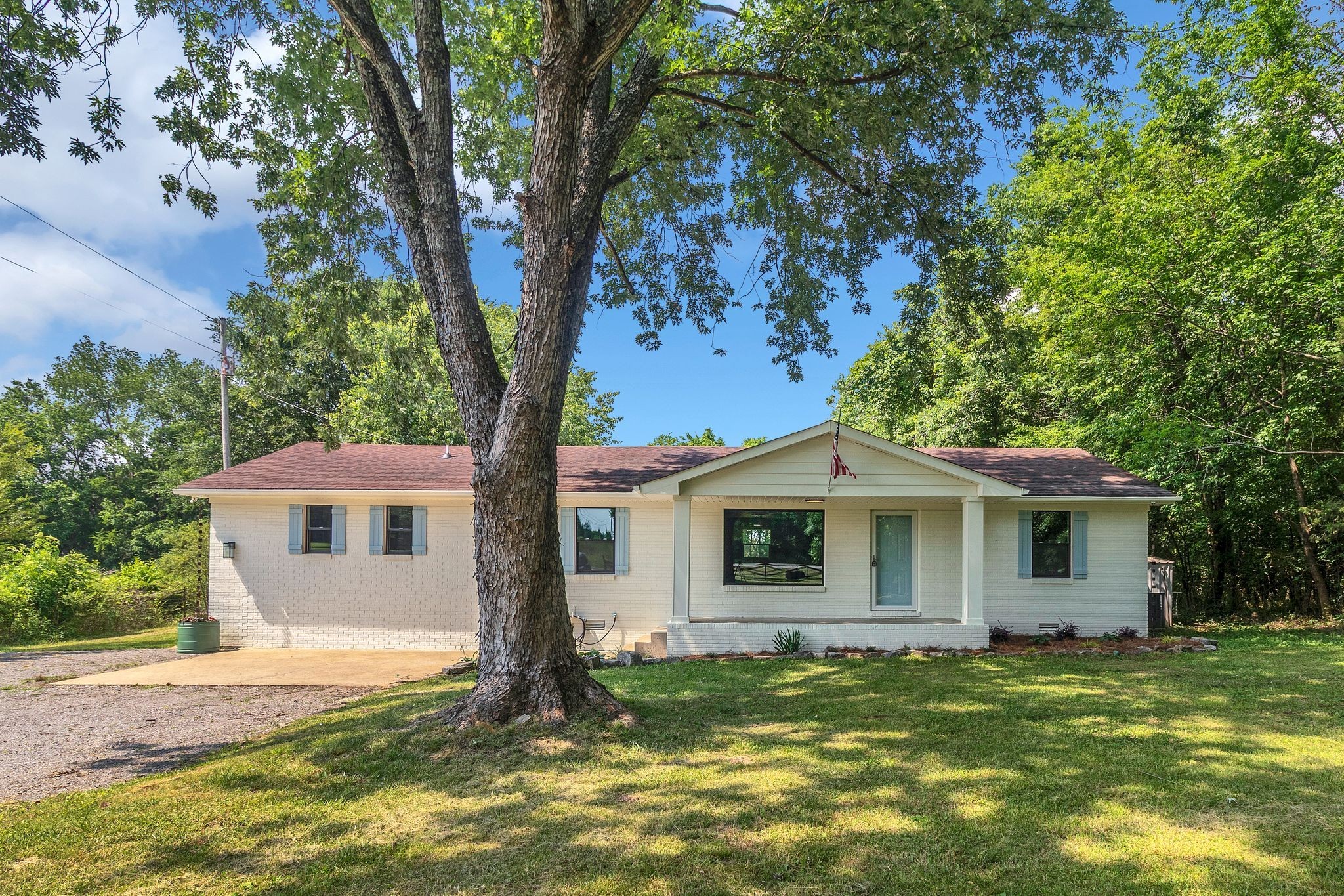 1441 Compton Road Murfreesboro, TN 37130 - Photo 2 of 26 a view of a yard in front of a house with plants and large tree