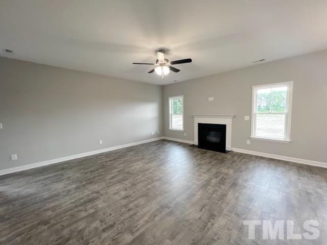 620 Ballance Road Fremont, NC 27830 - Photo 16 of 40 an empty room with wooden floor fan and windows