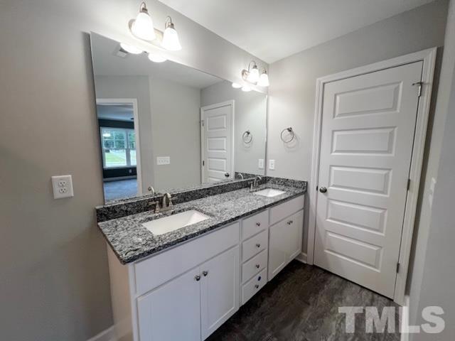 620 Ballance Road Fremont, NC 27830 - Photo 23 of 40 a bathroom with a granite countertop double vanity sink and a mirror