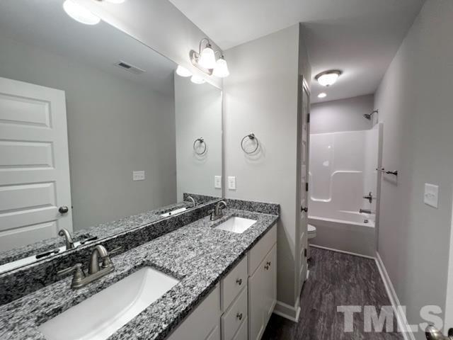 620 Ballance Road Fremont, NC 27830 - Photo 29 of 40 a bathroom with a granite countertop double vanity sink and mirror